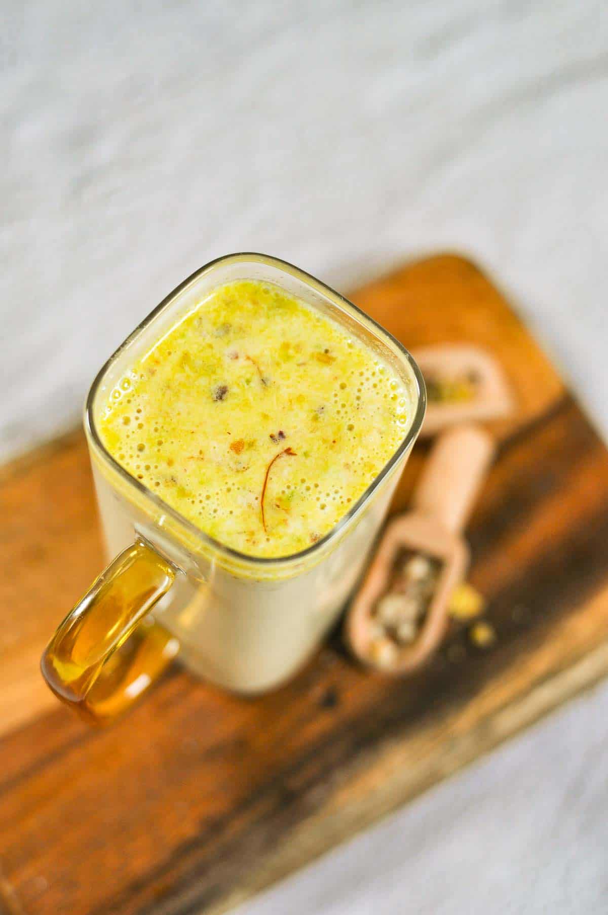 Safrron milk filled in a square glass mug. - 1