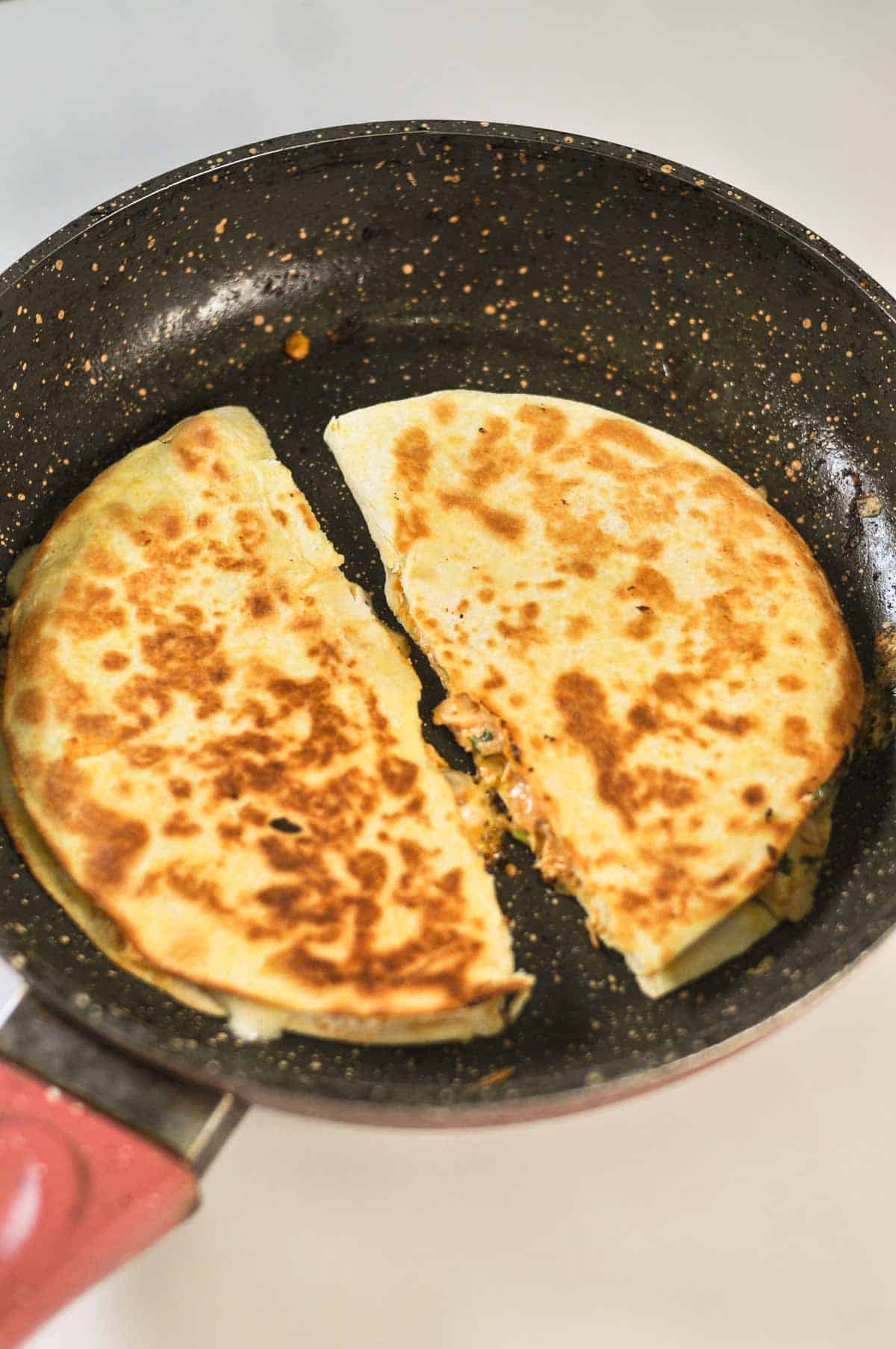 Crispy and toasted buffalo quesadilla in the pan. 