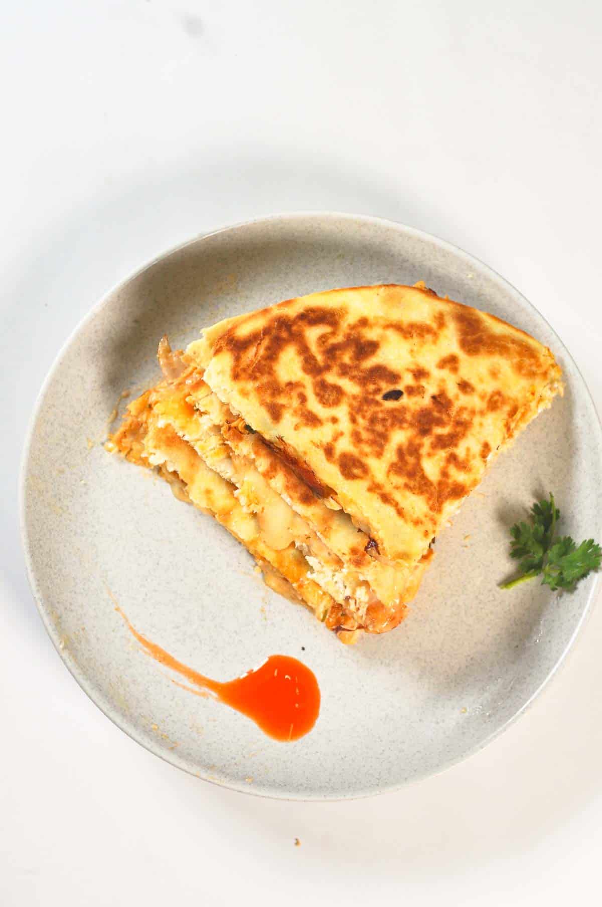 Stacked buffalo quesadilla on a ceramic plate.